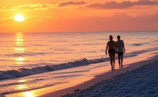 A couple walking the beach at sunset