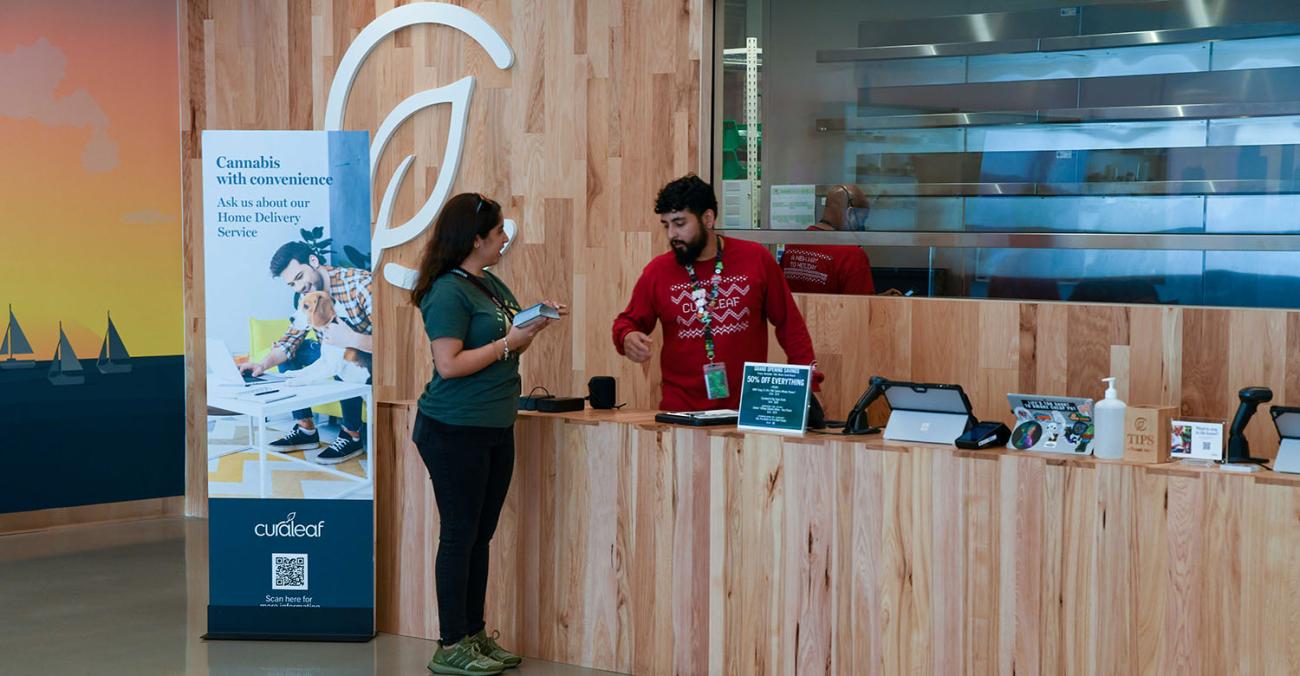 Photo of Curaleaf dispensary staff member assisting a patient