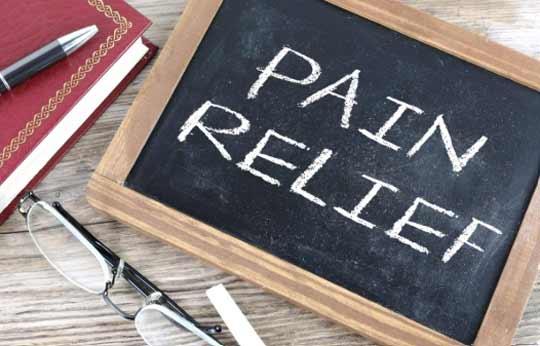 A small chalkboard with the words "PAIN RELIEF" written on it.