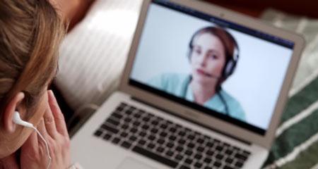 Two people i a video conference. One appears to be a medical associate.