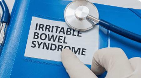 A medical professional pointing to an article about Irritable Bowel Syndrome