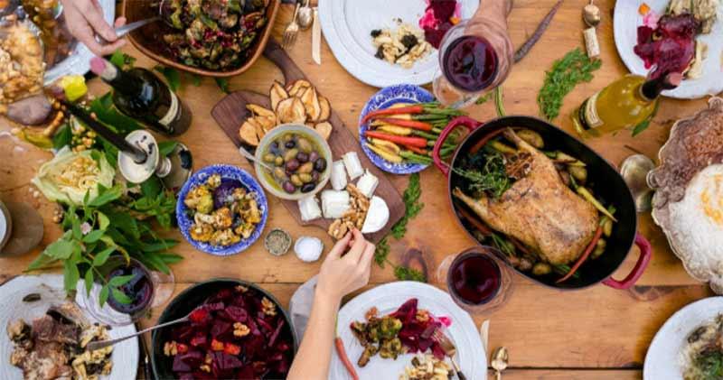 Looking down at a tabled filled with Thanksgiving offerings.